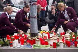 Germanwings flight attendants placing candles and flowers at the company's headquarters in Cologne, Germany