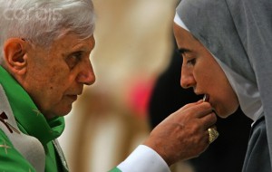 Pope Benedict XVI gives the communion to a nun during a solemn mass in Saint Peter's Basilica at the Vatican