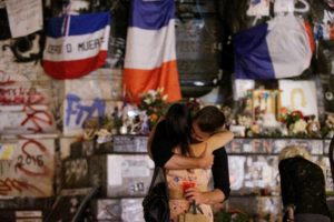 Mourners in Paris at a makeshift memorial for Father Hamel