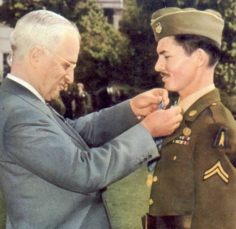 PFC Doss receives the CMA from President Truman