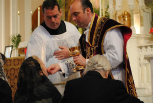 The faithful kneeling at the altar rail to receive Holy Communion