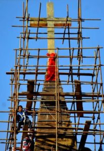 In this 2010 file photo, a worker climbs scaffolding surrounding a church in Qingdao, China. Two excommunicated bishops in China have ordained priests in separate ceremonies during the past two months. (CNS photo/Wu Hong, EPA) See CHINA-ORDAIN-ILLICIT Aug. 14, 2015.