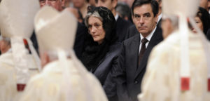 French prime minister Francois Fillon (C) and his wife Penelope wait for Pope Benedict XVI 's arrival during the canonisation ceremony of the blesseds, Ukrainian Zygmunt Szczesny Felinski , Spanish Francisco Coll y Guitart, Belgian Josef, Daamian de Veuster, Spanish Rafael Arnaiz Bar?n, French Marie de la Croix (Jeanne) Juganon In St. Peters's basilica at the Vatican on October 11, 2009. AFP PHOTO / ALBERTO PIZZOLI (Photo credit should read ALBERTO PIZZOLI/AFP/Getty Images)